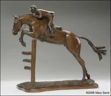 Horse sculpture of a young hunter jumper taking off over a jump.  Sculpture of jumper is titled Young Hunter and is a bronze limited edition of 15